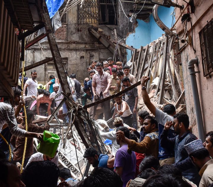 Rescuers work at the site of a building that collapsed at Dongri on July 16, 2019 in Mumbai.