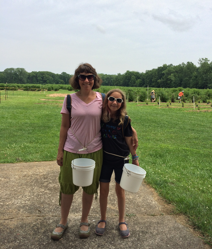 Lewis and Sammi picking blueberries in Michigan.