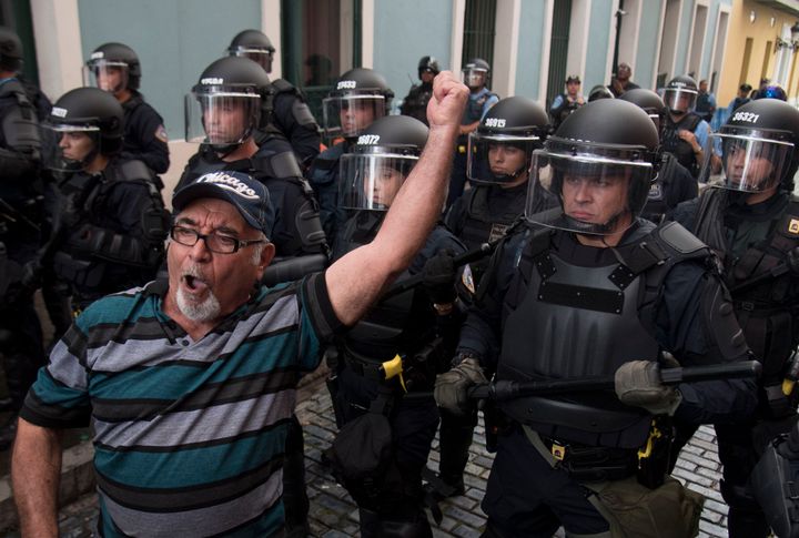 Police block demonstrators from advancing to La Fortaleza governor's residence in San Juan, Puerto Rico, Sunday, July 14, 2019.