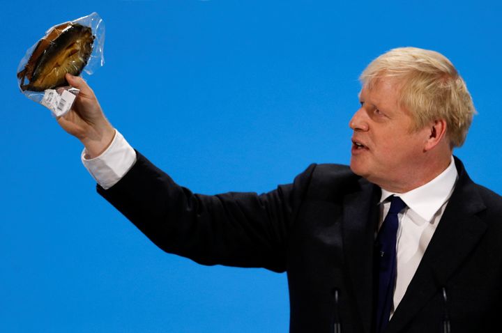 Boris Johnson, a Tory leadership candidate, holds a plastic wrapped kipper fish during a hustings event in London.