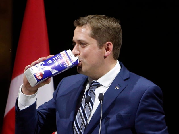 Conservative Leader Andrew Scheer drinks milk as he takes the stage at the National Press Gallery Dinner...