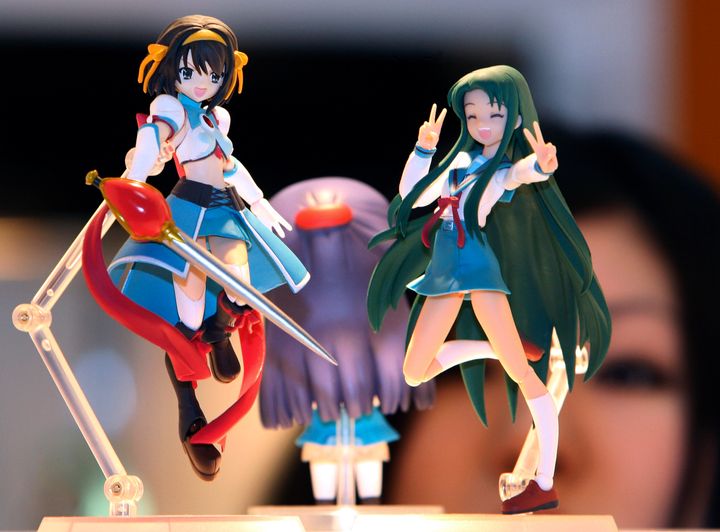 The studio is known for a host of famous characters, including Suzumiya Haruhi, left, seen here at an anime fair in Tokyo.