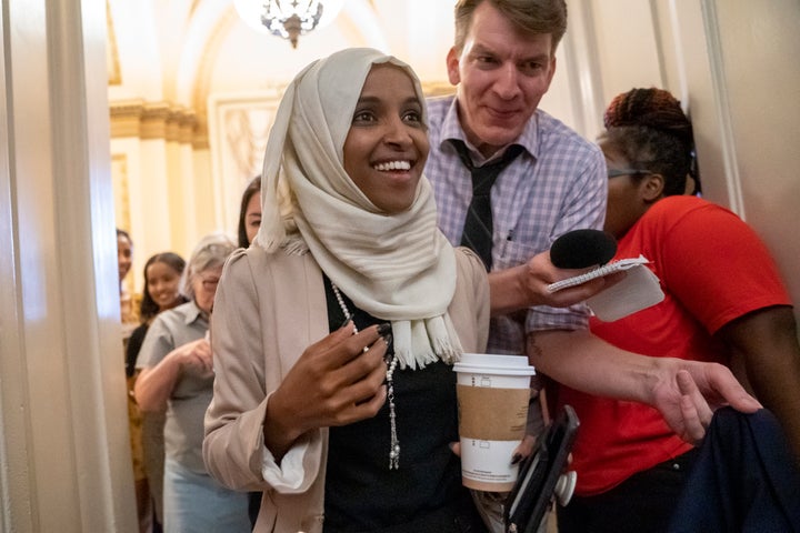 Rep. Ilhan Omar, D-Minn., a target of racist rhetoric from President Donald Trump, responds to cheers from visitors at the Ca