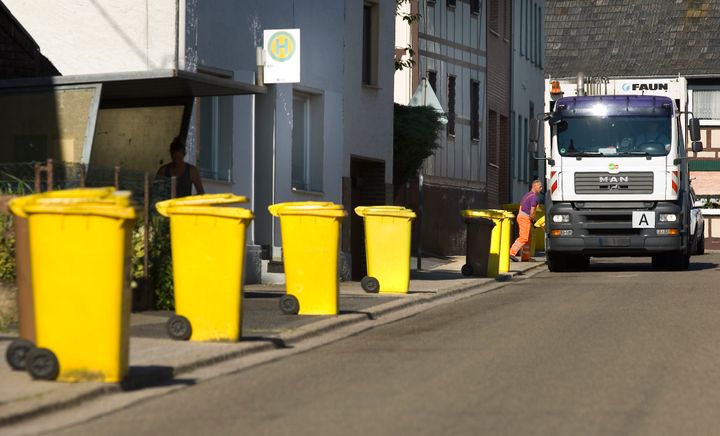 Yellow recycling bins, for packaging, plastic and metal, await collection.