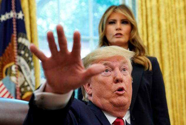 First lady Melania Trump listens as US President Donald Trump speaks to reporters in the Oval Office earlier this week.