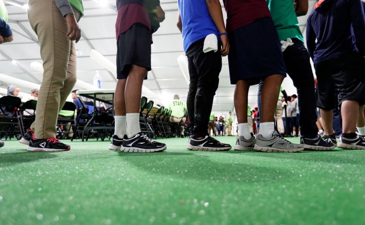 Migrants line up in the dining hall at the U.S. government's newest holding center for migrant children in Carrizo Springs, Texas, on July 9.