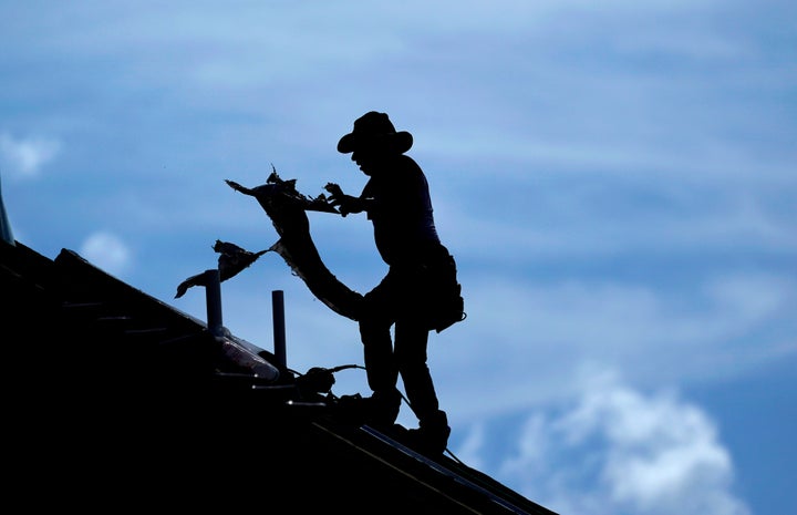 A roofer works on a home under construction in Houston Thursday. A heat wave is expected to send temperatures soaring close to 100 degrees through the weekend across much of the country.