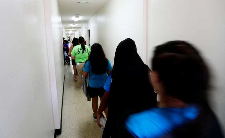 Immigrants walk down the hall of a dormitory at the U.S. government's newest holding center for migrant children in Carrizo Springs, Texas, on July 9.