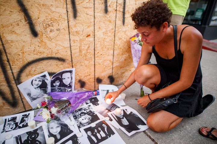 Desirae Shapiro, friend of shooting victim Reese Fallon, leaves a candle at a makeshift memorial on Danforth, Ave. July 23, 2018.