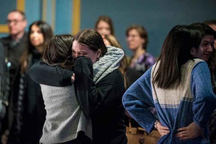 Survivors and loved ones affected by the shooting hug following their first public statement as a group at the Danforth Music Hall on Feb. 22, 2019.