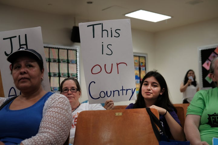 Some of Ocasio-Cortez's diverse constituents brought home-made signs to an immigration town hall on Saturday.