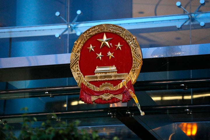 An egg thrown by a protester hits the National Emblem of the People's Republic of China at the Chinese Liaison Office in Hong Kong.