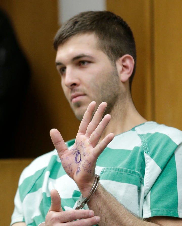 Comello displayed writing on his hand that included pro-Donald Trump slogans during his extradition hearing in Toms River, N.J., Monday, March 18, 2019. (AP Photo/Seth Wenig)