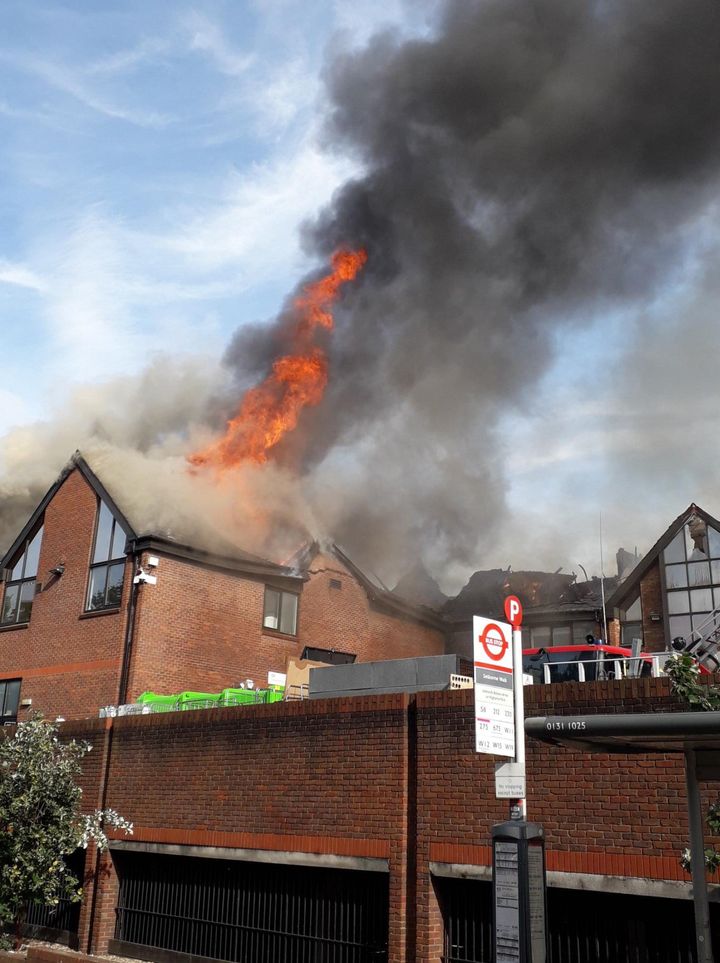 Flames rise from the roof of the shopping centre.