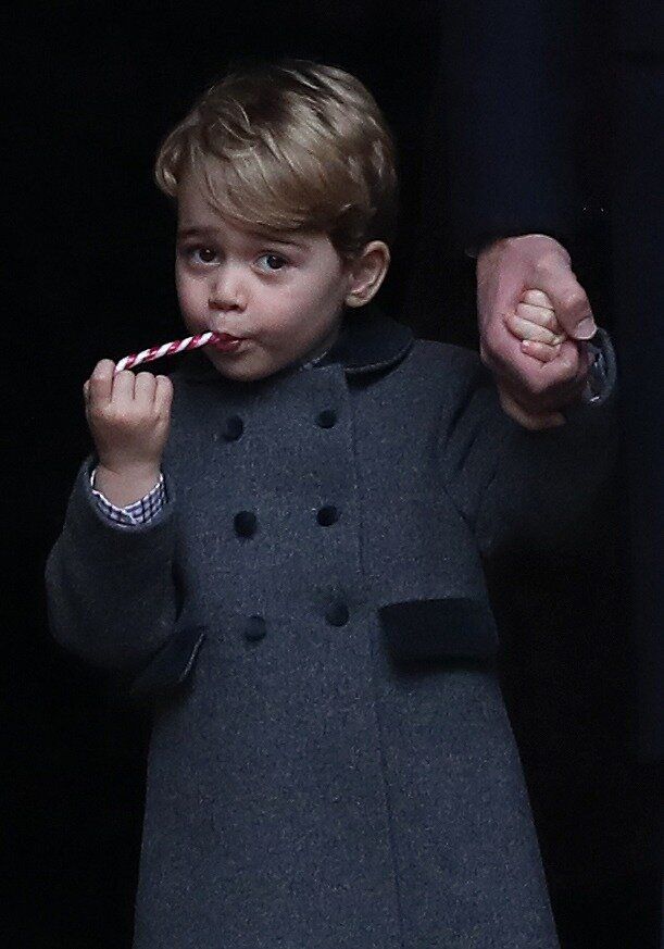 Prince George eats a sweet following the service at St Mark's Church on Christmas Day on Dec. 25, 2016 in Bucklebury, Berkshire.