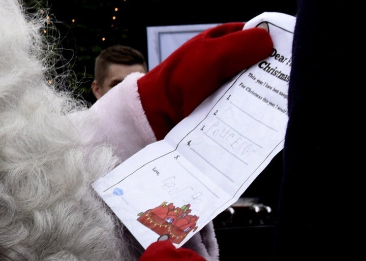 Prince William hands over a wish list by his son Prince George to Santa Claus as he visits the Esplanade Park and the Manta's Market winter fair in Helsinki, Finland, on Nov. 30, 2017.