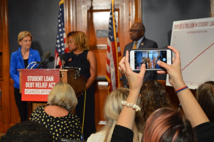 Howard University Ph.D. student Ashley Murray (center) talks about her struggles with student loan debt as Warren and Clyburn look on.