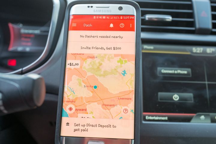 Close-up of a smartphone displaying the Dasher app for food delivery service Doordash.