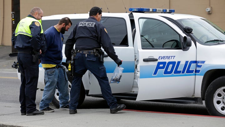 Everett Police officers arrest a man with an outstanding warrant near the Smith Ave. Bridge in Everett, Washington, which is a constant gathering place for homeless people battling addiction and mental illness. The hardcore homeless represent a major financial burden on Everett, putting pressure on jail, emergency room and other services.