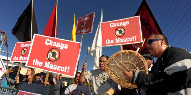 DENVER, CO - OCTOBER 27: From right to left Kordell Kills Crow, Gerard Montour and Chuntay Her Many Horses sing and play the drums during their protest outside of Sports Authority Field at Mile High in Denver, Co on October 27, 2013. The protestors are against what they perceive as the 'racist' Washington NFL team, and the name of their mascot the Washington Redskins in Denver, Co on October 27, 2013. (Photo By Helen H. Richardson/ The Denver Post)