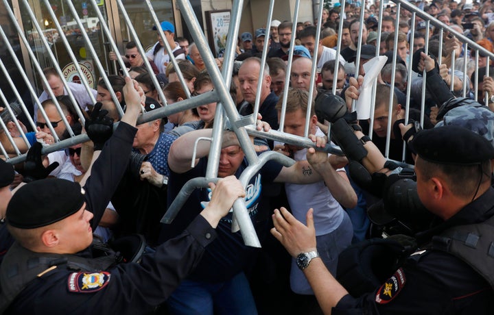 Protesters clash with police during an unsanctioned rally in the center of Moscow, Russia, Saturday, July 27, 2019. Russian police are wrestling with demonstrators and have arrested hundreds in central Moscow during a protest demanding that opposition candidates be allowed to run for the Moscow city council. (AP Photo/ Pavel Golovkin)