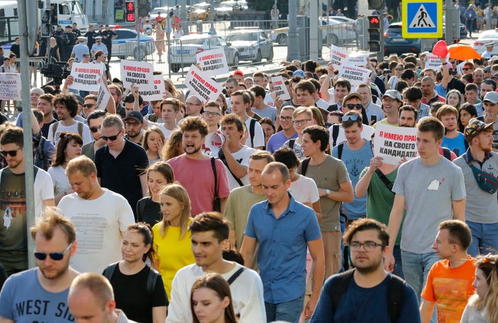 Protesters hold posters that read: "I have the right to my candidate" during an unsanctioned rally in the center of Moscow, R