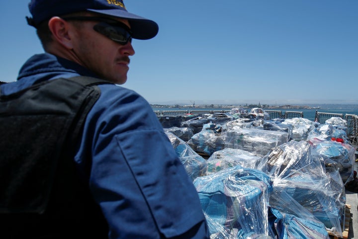 A Coast Guard agent watches over more than 13 tons of cocaine seized off the coasts of Mexico and Central South America before they are unloaded from the Coast Guard Cutter Steadfast at port in San Diego on Friday.