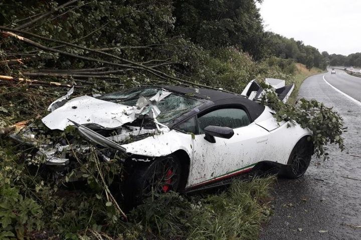 Greater Manchester Police said the driver lost control of the hired luxury car on standing water before taking out a section of barrier.