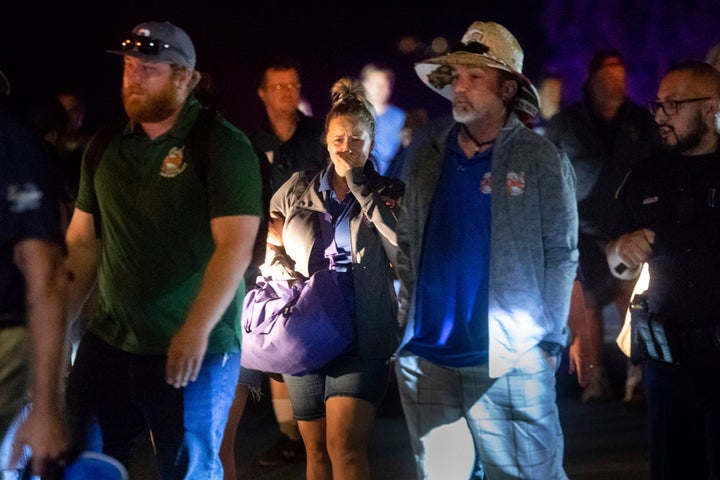 Police officers escort people from Christmas Hill Park following a deadly shooting during the Gilroy Garlic Festival, in Gilroy, Calif., on Sunday.