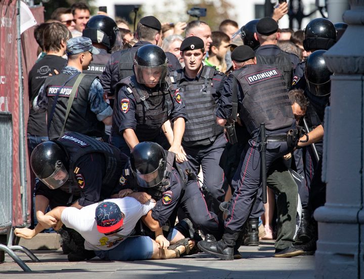 Police officers detain protesters during an unsanctioned rally in the center of Moscow, Russia on Saturday.