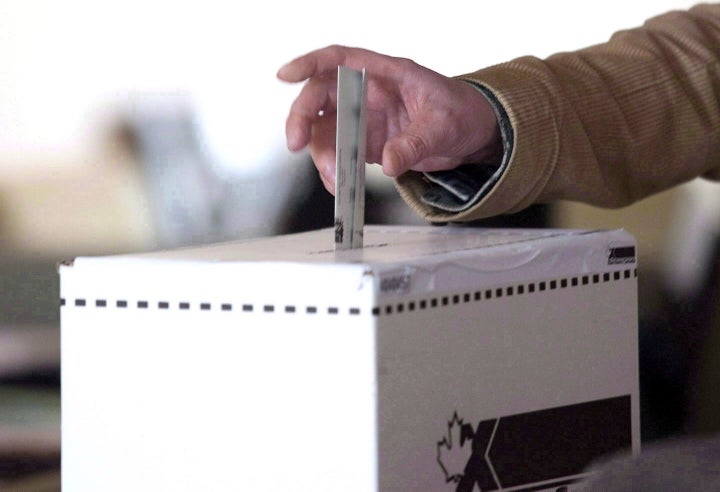 A voter casts a ballot in the 2011 federal election in Toronto on May 2, 2011.