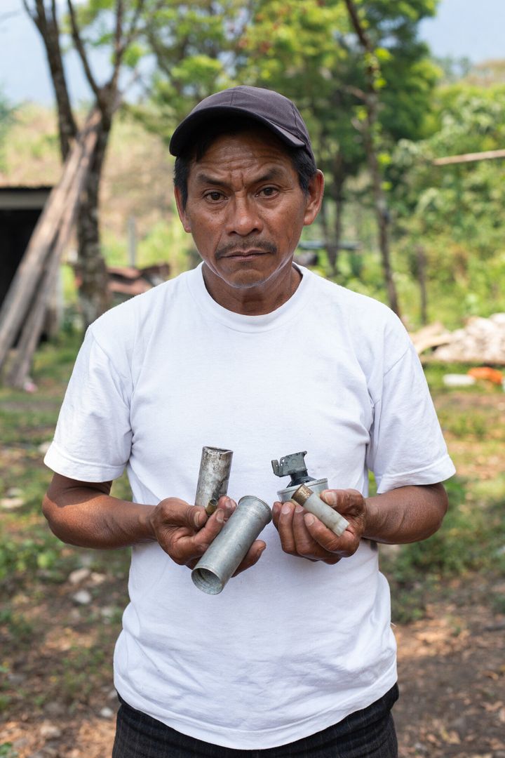 Joel Raymundo Domingo, 55, photographed in April, holds smoke bombs, tear gas canisters and other projectiles used by Guatemalan state forces to disperse a peaceful blockade against the San Mateo Hydroelectric Project, in October 2018. 