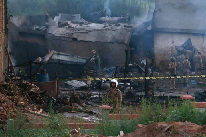 Pakistan army officials examine the site of a plane crash in Rawalpindi, Pakistan, July 30, 2019