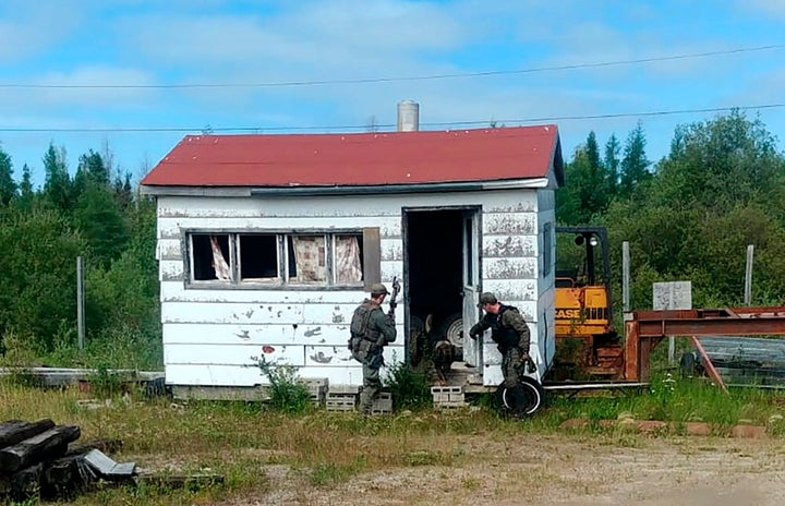 This RCMP photo shows officers searching for murder suspects in Gillam, Man., earlier this month. So far, the alleged killers have not been found.