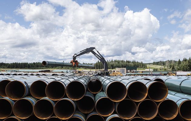 Pipe for the Trans Mountain pipeline is unloaded in Edson, Alta. on Tuesday June 18,