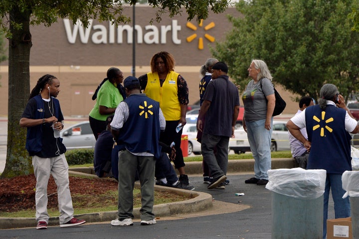 Employees gather in a nearby parking lot after a shooting at a Walmart store Tuesday, July 30, 2019 in Southaven, Miss.