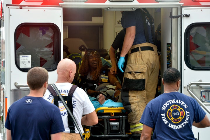 A Walmart employee receives medical attention after a shooting at the store, Tuesday, July 30, 2019, in Southaven, Miss.