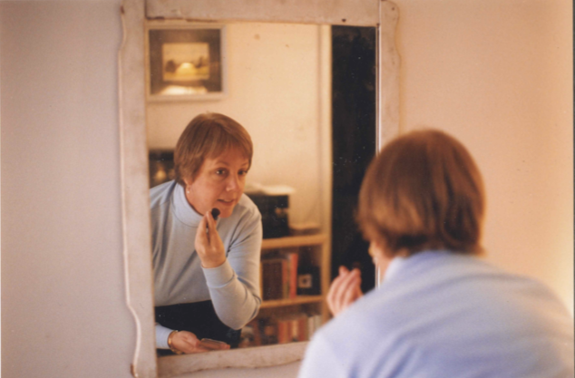 Dan Kellum's mom putting on makeup in his first New York apartment in 2000.