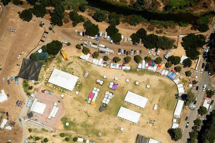 In this aerial photo, vendor booths line Christmas Hill Park, Monday, July 29, 2019, in Gilroy, Calif., the site of a shooting the day before at the Gilroy Garlic Festival.