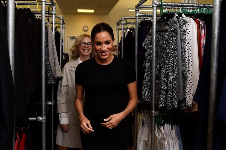 Meghan Markle and Lady Juliet Hughes-Hallett walk through racks of clothes during her visit to Smart Works on Jan. 10, 2019 in London.