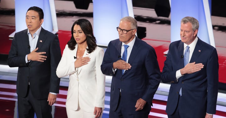 Entrepreneur Andrew Yang, Rep. Tulsi Gabbard, Washington Gov. Jay Inslee and New York Mayor Bill de Blasio at the Democratic debate in Detroit on Wednesday night. 