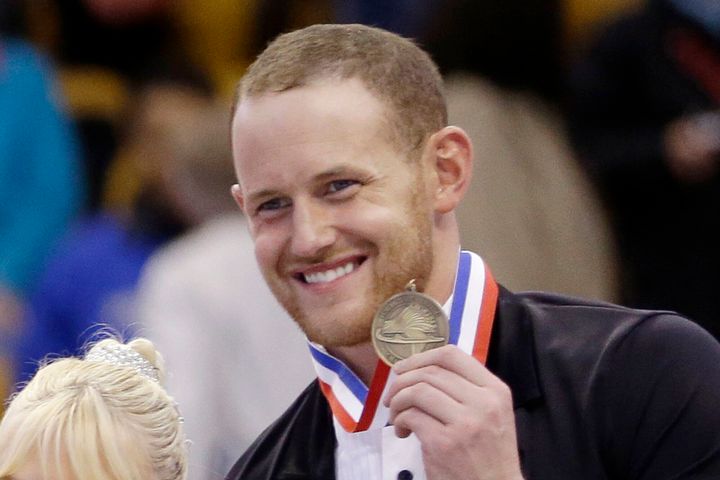 Bronze medalist John Coughlin smiles during a 2014 award ceremony at the U.S. Figure Skating Championships in Boston. Coughlin died by suicide in January amid an investigation into similar allegations of sexual misconduct by him.