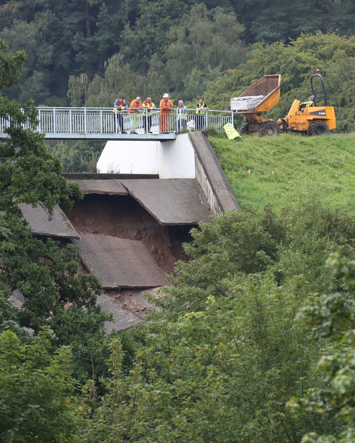 A team of engineers examine at the damage to the wall of Toddbrook Reservoir near the village of Whaley Bridge, Cheshire, after it was damaged in heavy rainfall
