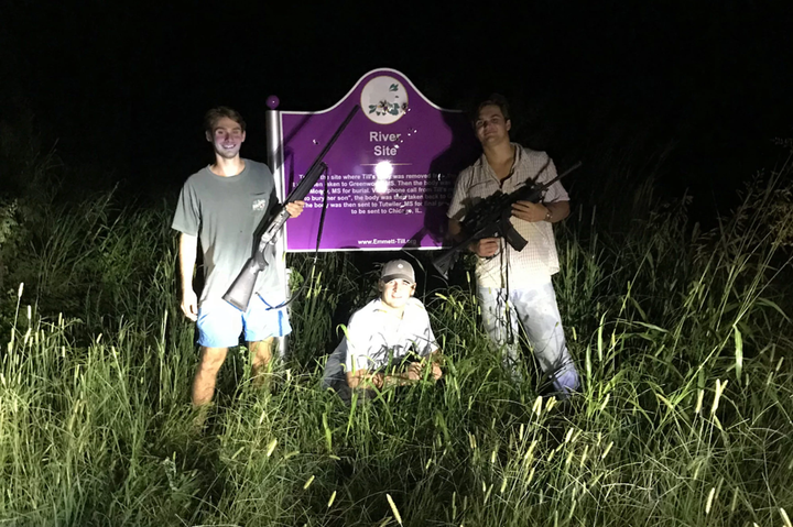 From left to right, Ole Miss students Ben LeClere, John Howe, and Howell Logan posing with guns by the bullet-ridden plaque marking the place where the body of murdered civil rights icon Emmett Till was pulled from the Tallahatchie River. The photo was posted to LeClere's Instagram account in March.