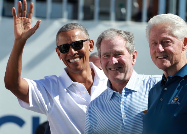 Presidents Obama, G.W. Bush and Bill Clinton pose at the first tee during the first round of the Presidents Cup at Liberty Na