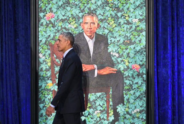Obama walks by his presidential portrait at the Smithsonian National Portrait Gallery in Washington, DC.
