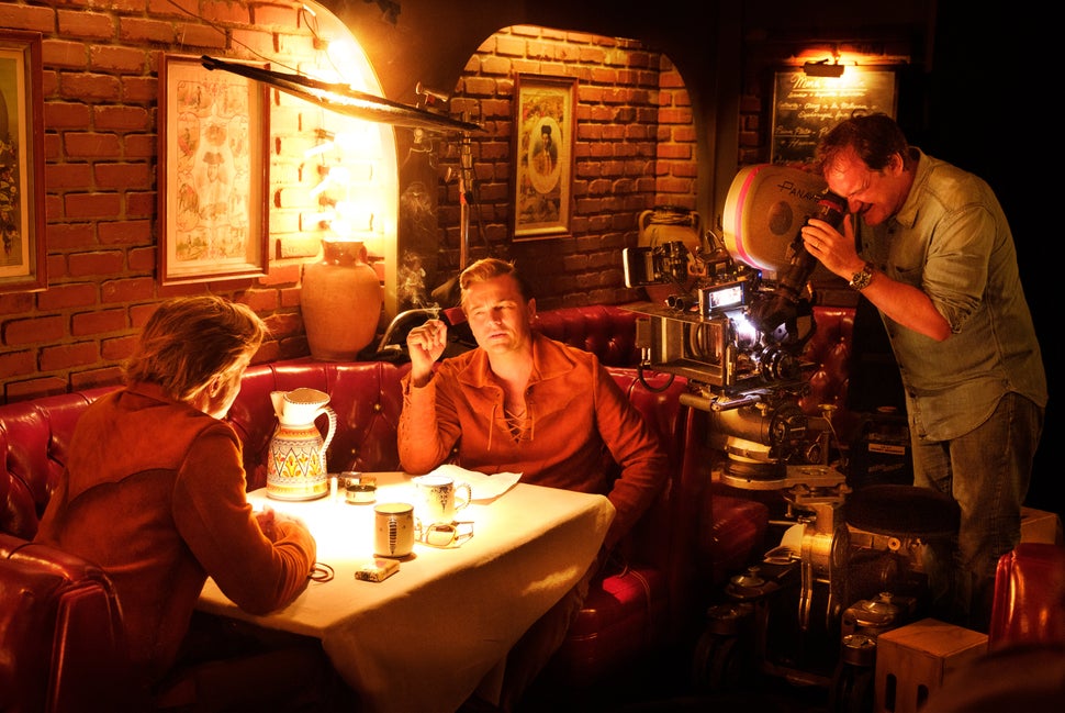 Quentin Tarantino shooting a "Once Upon a Time in Hollywood" scene with Brad Pitt and Leonardo DiCaprio.