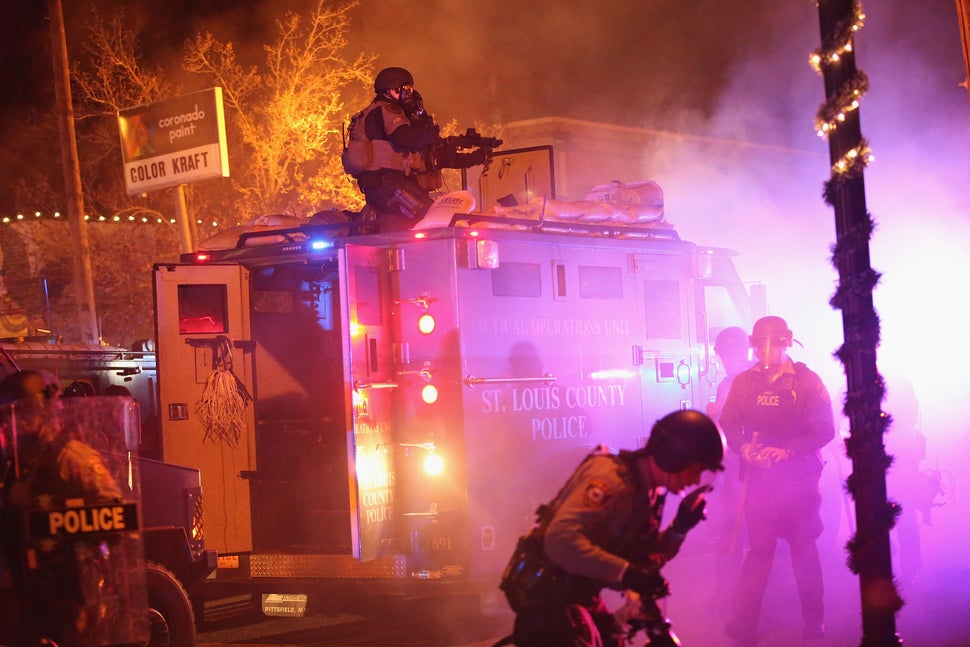 FERGUSON, MO - NOVEMBER 24: Police confront protestors after rioting broke out following the grand jury announcement in the Michael Brown case on November 24, 2014 in Ferguson, Missouri. Ferguson has been struggling to return to normal after Brown, an 18-year-old black man, was killed by Darren Wilson, a white Ferguson police officer, on August 9. His death has sparked months of sometimes violent protests in Ferguson. A grand jury today declined to indict officer Wilson. (Photo by Scott Olson/Getty Images)