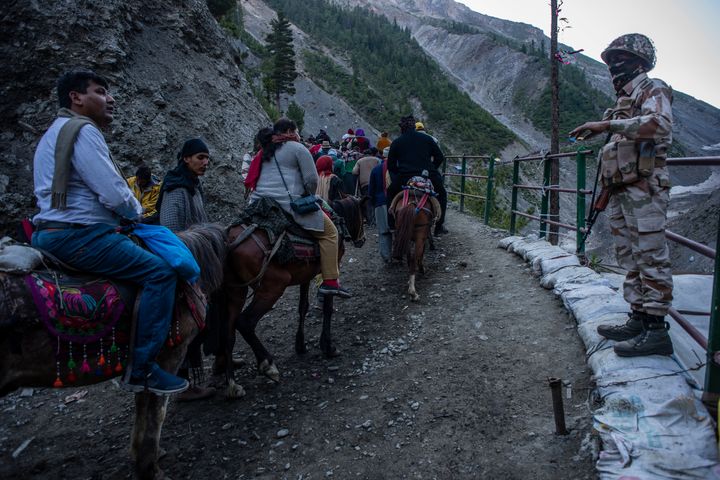 Government forces stand guard as people make their pilgrimage to the Amarnath shrine, on July 1, 2019, in Baltal.