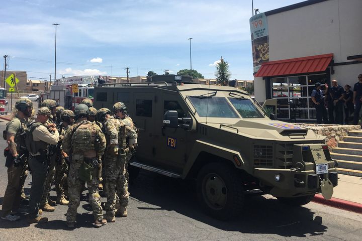 FBI authorities stand outside near an El Paso Walmart that has left multiple people dead.
